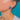 Blue Enamel scallop shell earring worn for scale